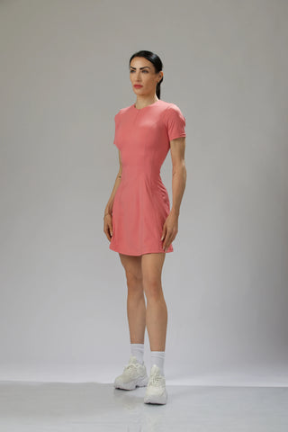 Peach Pink Athletic Dress Side View – Side view of a peach pink sports dress, emphasizing its flattering seams, soft stretch fabric, and breathable structure.
