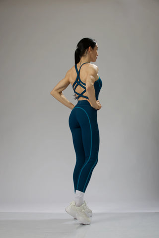 Reaux performance leggings in ocean blue, front-facing view with seamless high-waistband for structured support.
