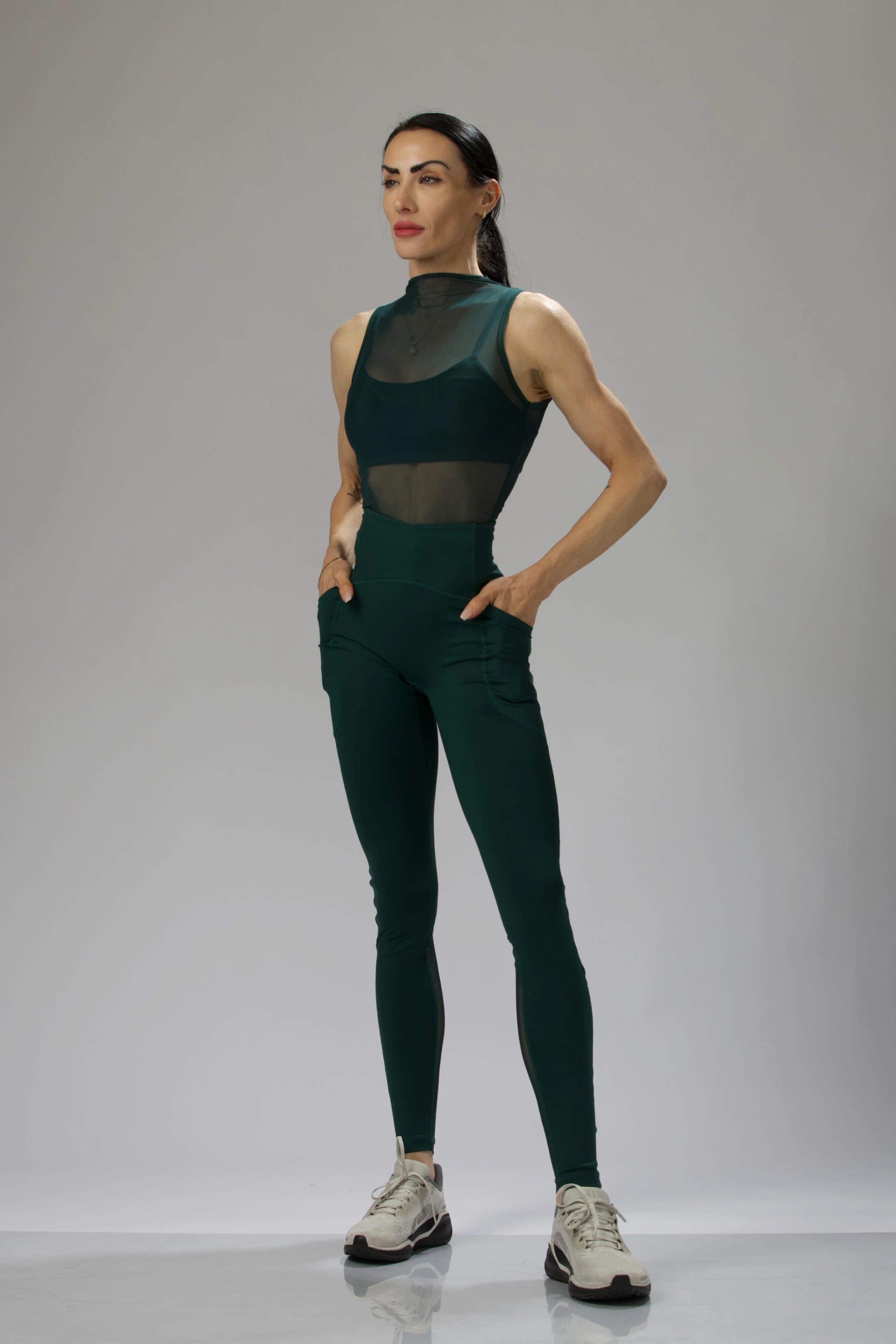 Reaux model wearing mesh-panel leggings, featuring a form-fitting high waist and subtle contouring, mesh top, and bra sets.